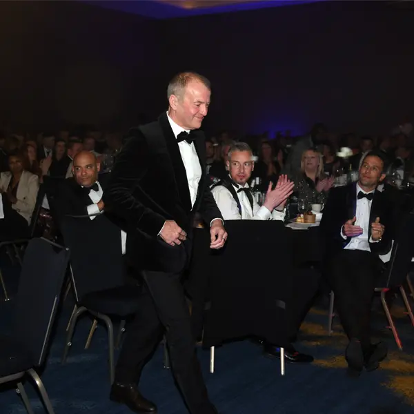 standing up to collect award