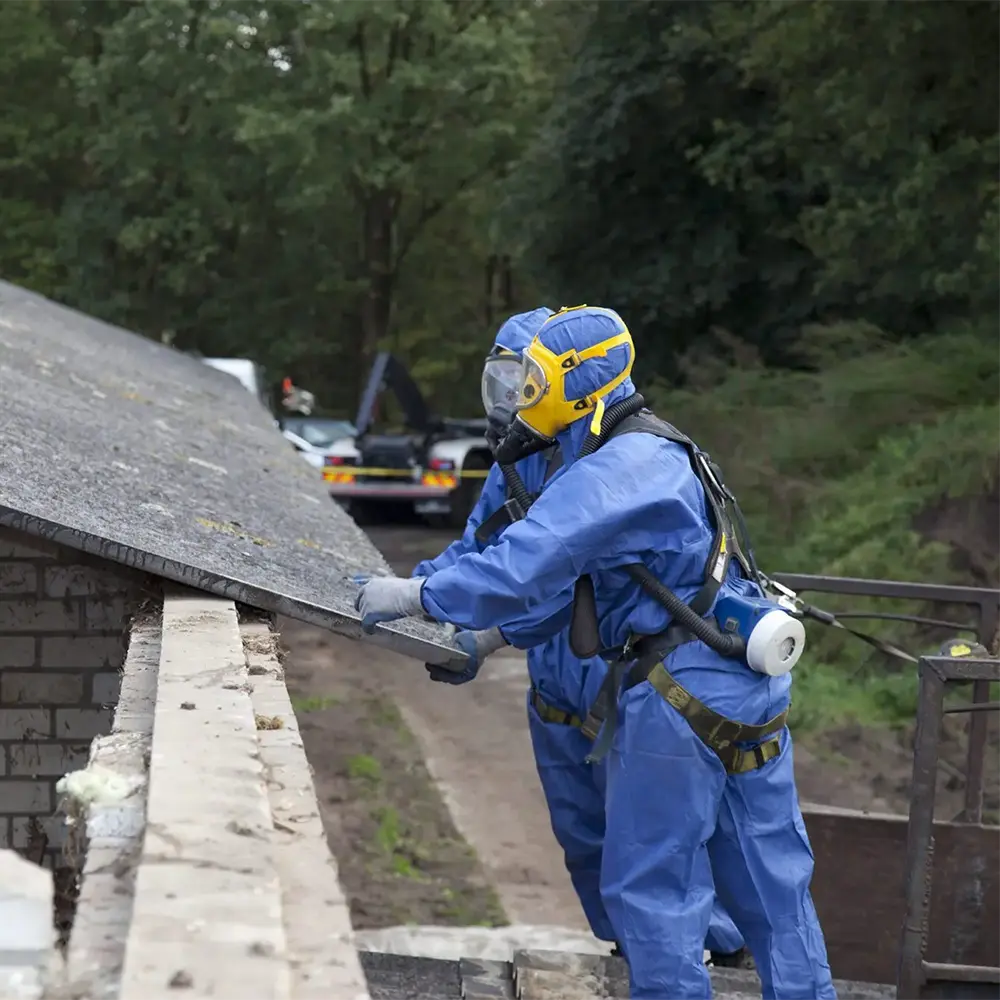asbestos workers in ppe working on roof
